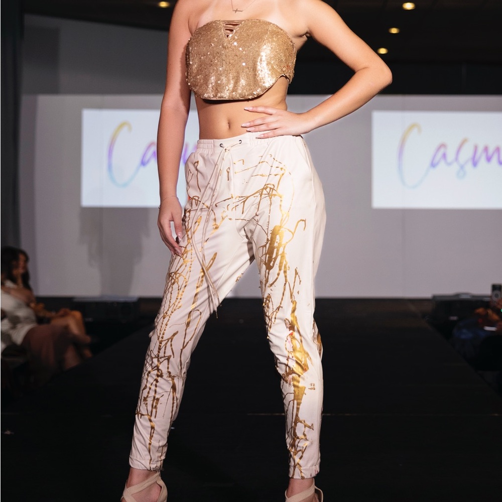 Cream pleather pants with gold abstract splatter paint.